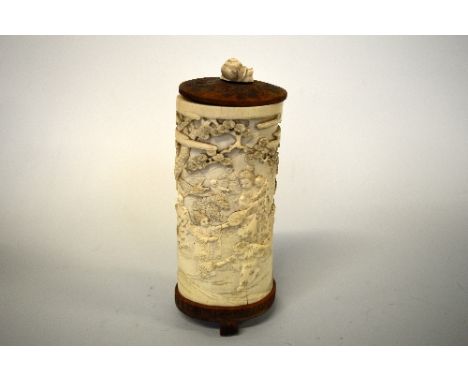 AN ORIENTAL CARVED TUSK, depicting woman and children in domestic scenes, in mountainous landscape with trees and blossom, ca