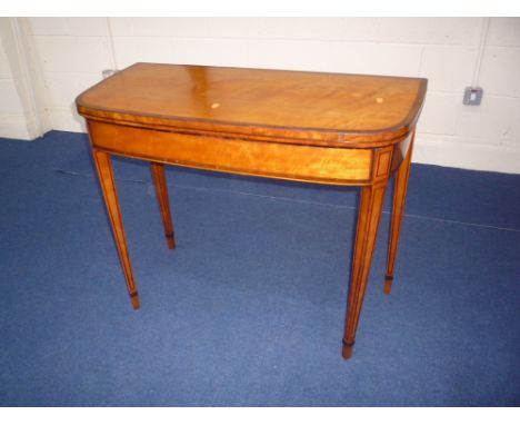 A SATIN BIRCH FOLDING CARD TABLE, with string inlay on tapering square legs with spade feet, beize playing surface, approxima