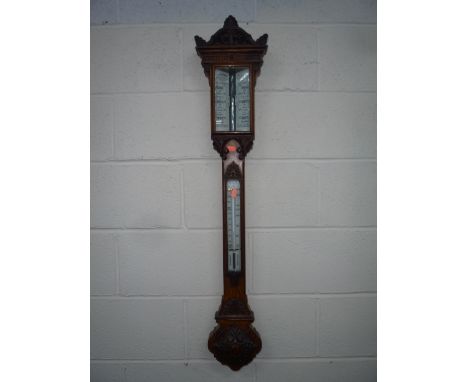 AN ENGLISH OAK STICK BAROMETER, J. Hicks, London, with double vernier, arched carved case with shell finial, thermometer scal