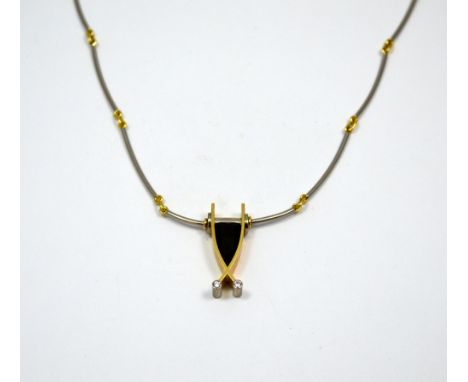 AN 18CT GOLD TOURMALINE AND DIAMOND NECKLACE, bi-coloured, with shield shape tourmaline flanked by yellow gold surround with 