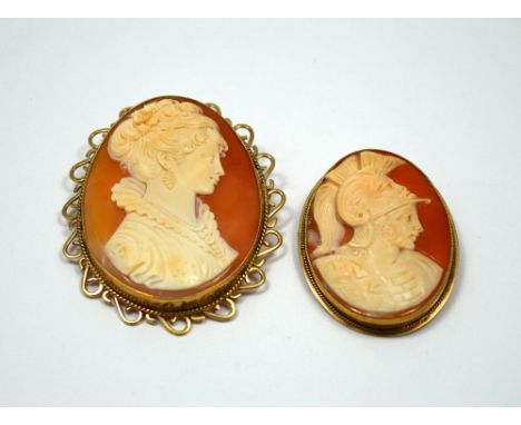 TWO CAMEO BROOCHES, the first of a Roman soldier in profile with shield and plume helmet, together with a cameo of a woman in