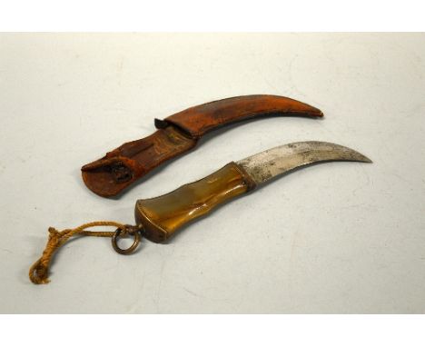 A HORN HANDLED KNIFE, with curved blade impressed M1 Ltd, in leather scabbard