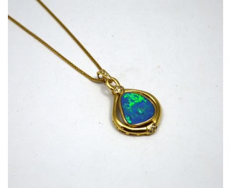 AN OPAL PENDANT NECKLACE, with abstract opal within a plain border with brilliant-cut diamond accents to the bail and bottom 