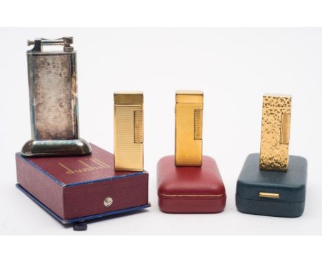 A silver plated Dunhill 'Standard' petrol table lighter in original box:, together with three gold plated vintage Dunhill lig