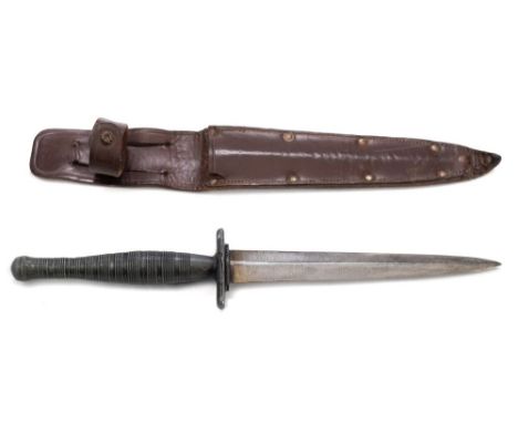 A Fairbairn-Sykes fighting knife, 3rd pattern:, unsigned, the 6 1/2 double edged blade over a single cast alloy hilt and ring