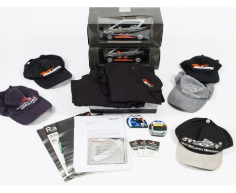 A West McLaren Mercedes 'Team McLaren' members boxed set:, including two polo shirts, pit lane passes,magazines and four Team