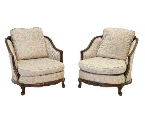 An Early 20th Century Carved Mahogany Three Piece Suite, circa 1920/30, recovered in pink and light green floral fabric, comp