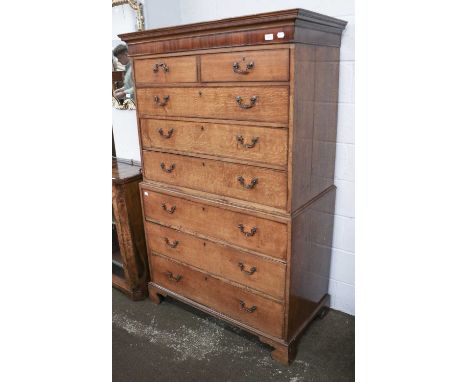 A George III Oak Chest on Chest, with mahogany frieze, pine linings, cock beading and raised on bracket supports, 108cm by 56