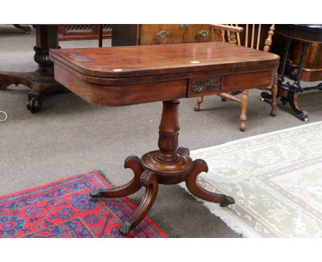 A Regency Mahogany Fold-over Card Table, crossbanded in Rosewood, and with acanthus carved reeded scroll supports, attached l