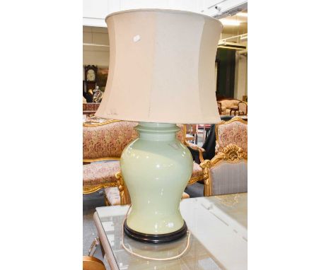 A Large Chinese Table Lamp, celadon ground and of baluster form, raised on a thin hardwood plinth and with silk shade, 51cm t