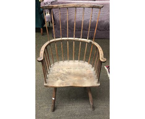 A 19th Century Provincial Ash and Elm Comb Back Windsor Chair (a.f)One spindle replaced, another repaired. The bowed arm stru