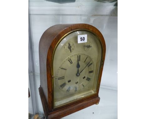 AN OAK CASED THREE TRAIN MANTLE CLOCK. 