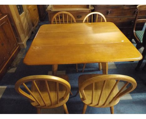 An Ercol Drop Leaf Dining Table and Four Chairs. 