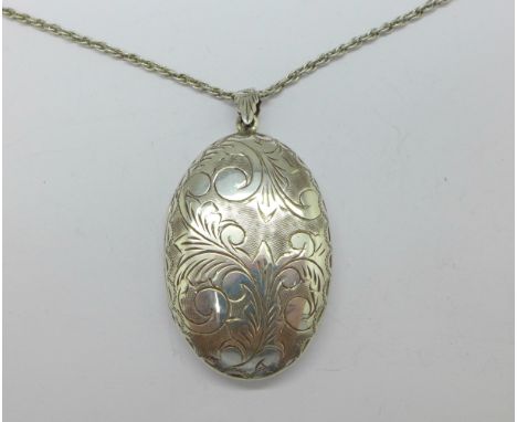 A silver locket and chain, height of locket 49mm