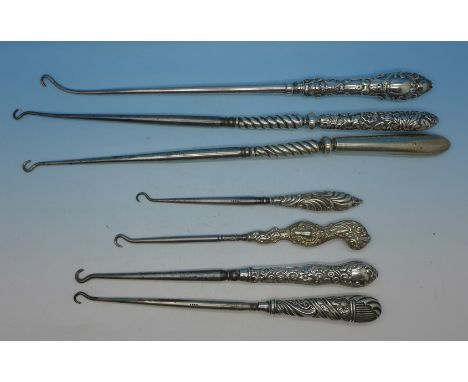 Seven silver mounted button hooks