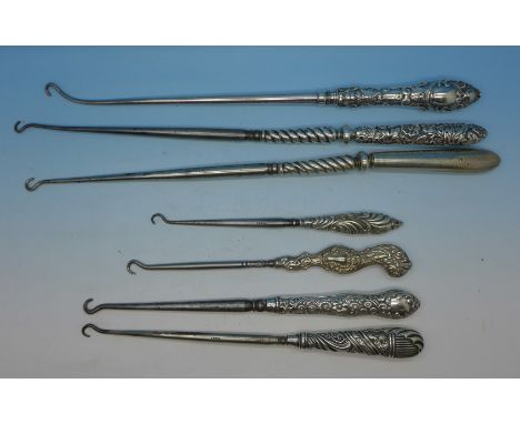 Seven silver mounted button hooks