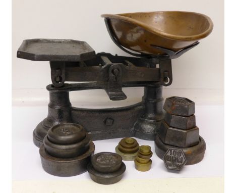 A set of traditional kitchen scales and weights including nine brass