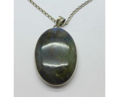 A large Labradorite pendant on a silver chain