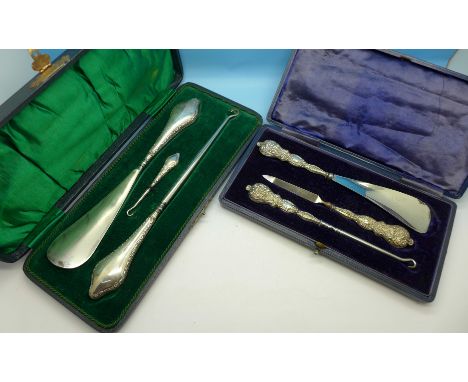 Two silver mounted button hook sets, cased