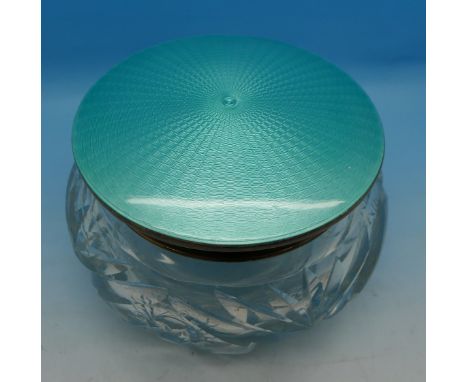 A large silver and enamel topped glass bowl with integral mirror