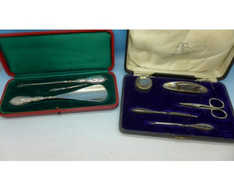 A cased silver manicure set and a cased silver button hook set