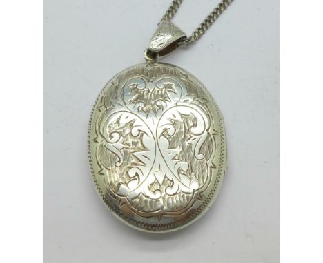 A silver locket and chain, marked Siam Sterling