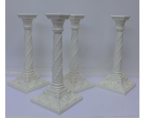 Four Royal Worcester candlesticks, 1050, one with small chip to side of base, 27cm