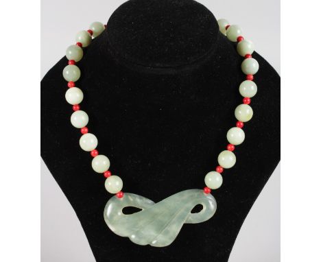 A GOOD ART DECO JADE AND CORAL BEAD NECKLACE with carved pendant.