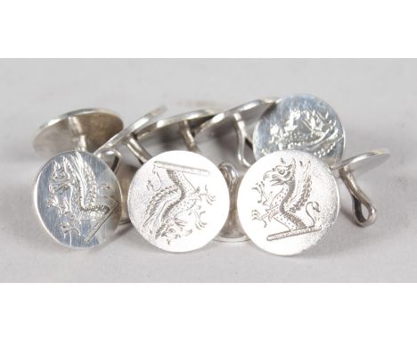 A BAG OF SILVER CUFFLINKS engraved with a dragon.