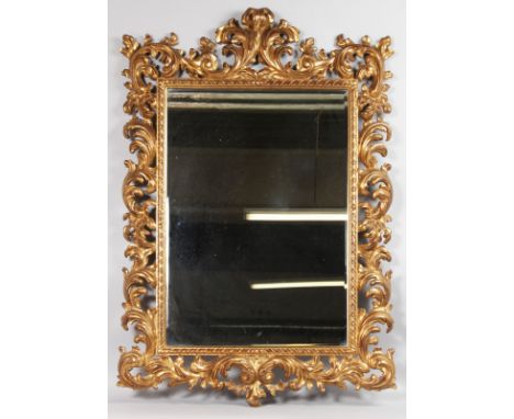 A GOOD 1920'S CARVED AND GILDED ITALIAN MIRROR. Overall size 3ft 7ins high, 2ft 5ins wide.