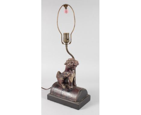 A MING POTTERY ROOF TILE converted to an electric lamp.