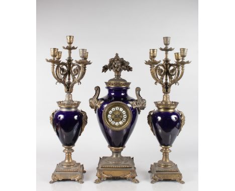 A LARGE 19TH CENTURY FRENCH BLUE PORCELAIN AND GILT METAL THREE PIECE CLOCK GARNITURE, the clock of urn shape with vase of fr