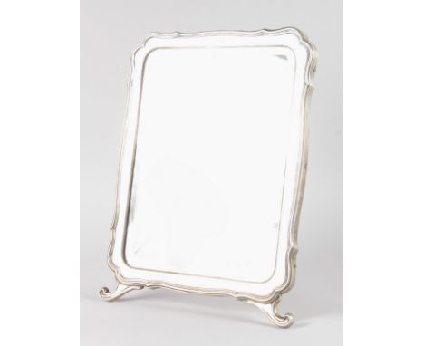 A LARGE RUSSIAN FABERGE SILVER EASEL MIRROR with shaped frame and bevelled glass. 18.5ins x 14ins overall.  Russian silver ma