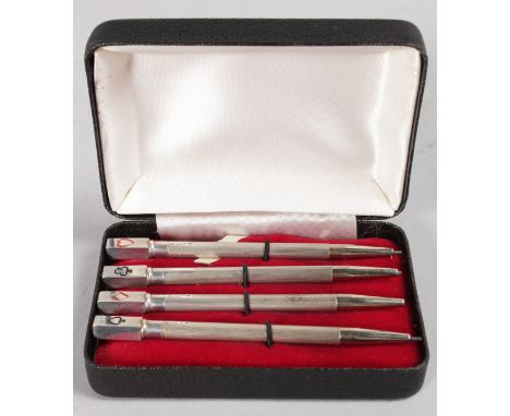 A SET OF FOUR SILVER PENCILS engraved with playing cards. Birmingham 1955, in a box.