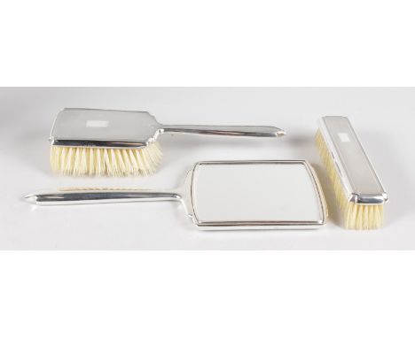 A GOOD EDWARDIAN SILVER BACK HAND MIRROR AND TWO BRUSHES in original case. Birmingham 1913.