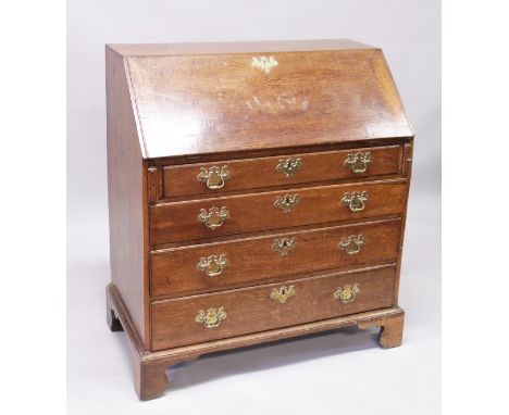 A GOOD GEORGE III OAK BUREAU, with fall front and fitted interior, over four long graduated drawers with brass handles, suppo