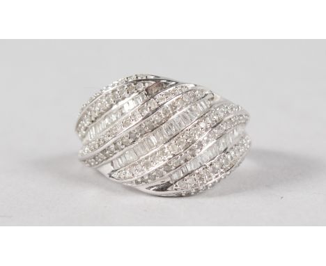 A LOVELY 9CT WHITE GOLD, DIAMOND AND BAGUETTE DIAMOND WAVE BAND RING.