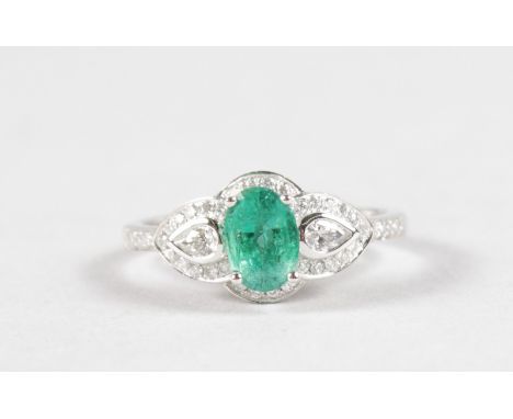 A GOOD 18CT WHITE GOLD, EMERALD AND DIAMOND RING.