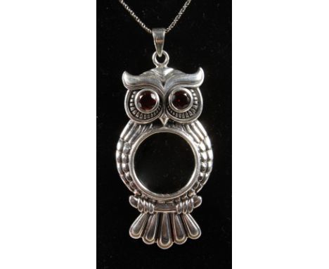 A SILVER OWL SPY GLASS on a silver chain.