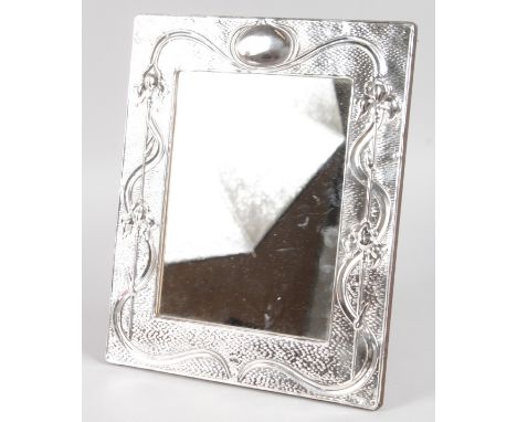 A LARGE .925 SILVER ART NOUVEAU DESIGN PHOTOGRAPH FRAME decorated with scrolls and flowers. 11.5ins high, 9ins wide.