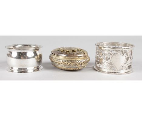 AN ENGRAVED OVAL BRASS SNUFF BOX and two serviette rings.