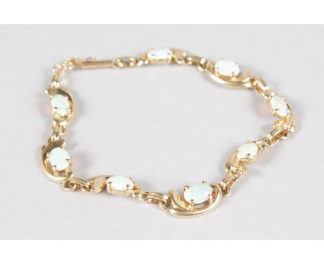 A 14CT YELLOW GOLD OPAL SET BRACELET.