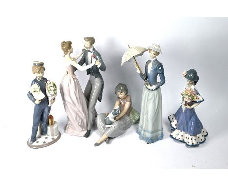 Three Lladro figures, dancing couple, bell-boy with flowers and gifts and Spanish girl with flowers to/w a Nao girl with kitt