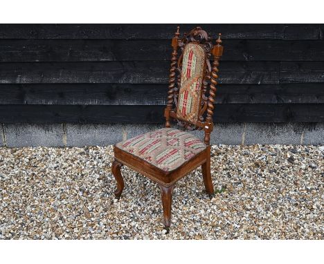 A Victorian carved walnut side chair with barley twist supports, tapestry upholstered back and seat and cabriole legs