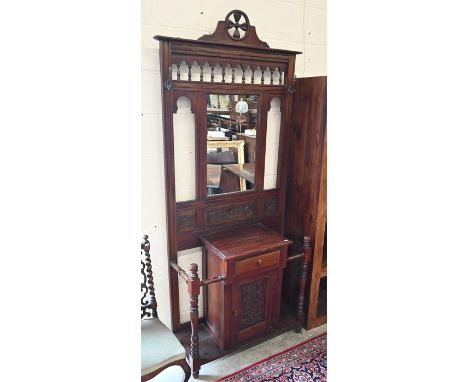 An Edwardian mahogany mirror-backed hall stand with carved panels and ring-turned supports, 90 cm wide x 37 cm deep x 210 cm 