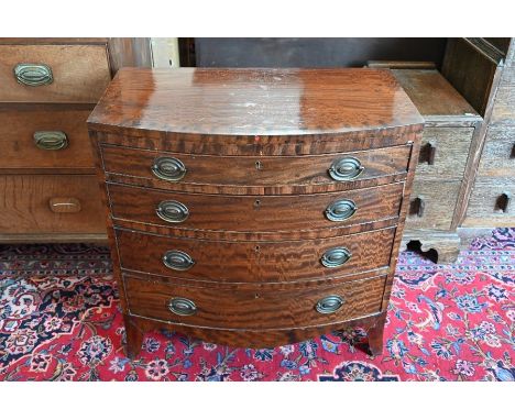 A small mahogany bow front chest of four long graduating drawers, raised on splayed bracket feet, 76 cm wide x 46 cm deep x 7