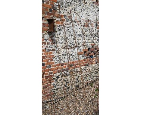 A pair of large weathered steel arrow-head garden obelisks, approx. 220 cm high x 38 cm diameter 