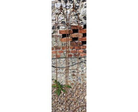 A pair of small weathered steel arrow-head garden obelisks, approx. 160 cm high x 23 cm diameter 