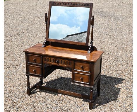 An Ercol mirror backed dressing table. length 114cm x width 48cm x height 76cm (+ 71cm x 71cm mirror)