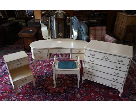 A French cream painted bedroom suite comprising mirror-backed dressing table and stool, five drawer chest and bedside cabinet